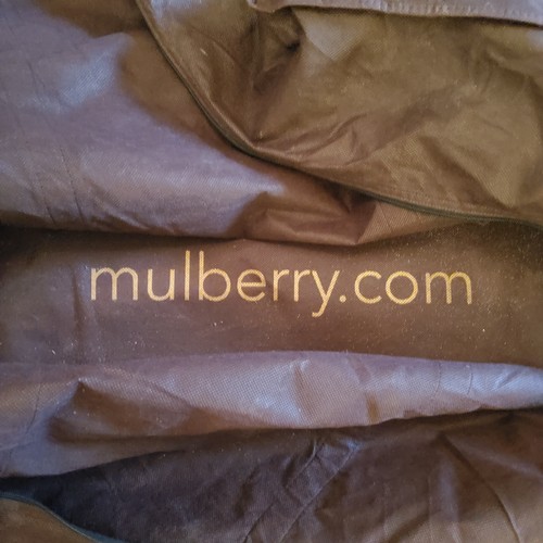 93 - A genuine Mulberry suitcase, large size, in original protective cover, 68w x 50h on casters