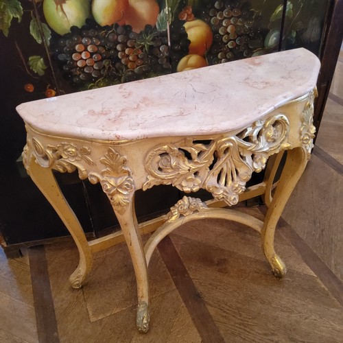 120 - An ornate Louis XVI style 'Roccoco' marble topped gilt wood console, serpentine shaped pink marble s... 