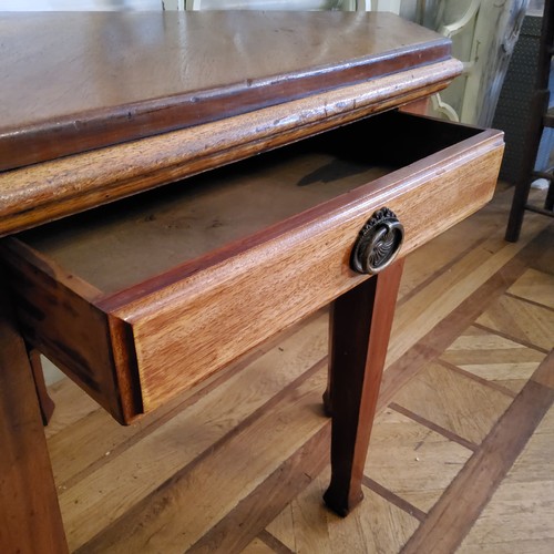 126 - An unusual late Victorian mahogany canted corner table with single drawer to frieze raised on taperi... 