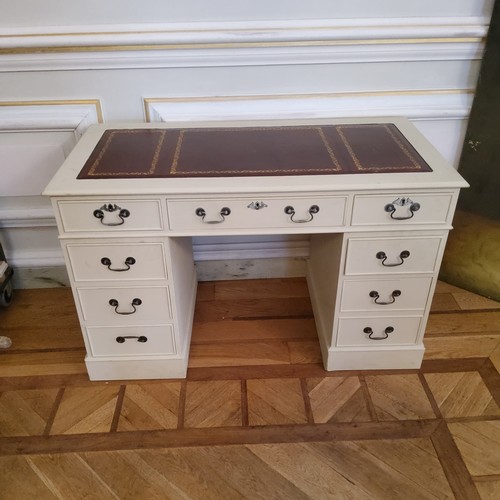 134 - A reproduction kneehole desk painted white, tooled leather inlay, 122cm long x 61cm deep x 76cm high