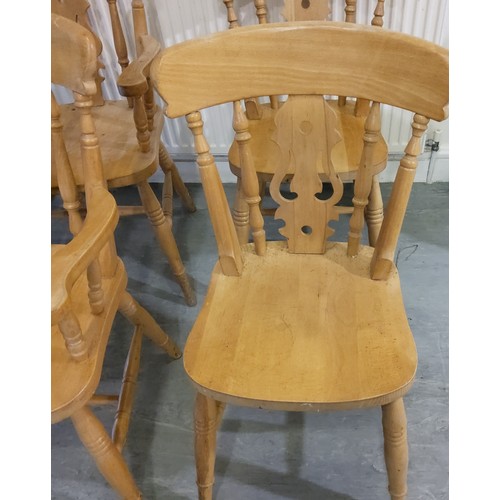 138 - A farmhouse pine kitchen table with four chairs including two carvers, the table support with brande... 