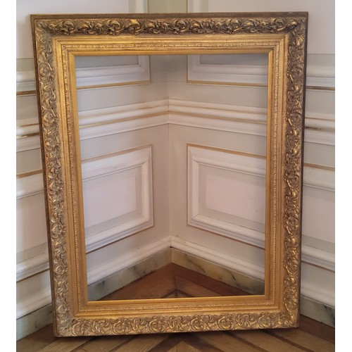 151 - A substantial decorative gilt picture frame in the florentine style 158cm high x 127cm wide by 10 cm... 