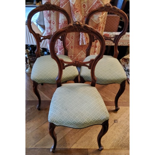 186 - Three carved mahogany balloon back salon chairs, cabriole legs, green upholstered seat, studwork