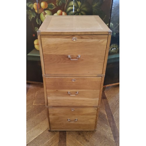 194 - A contemporary light oak campaign style three drawer filing cabinet with brass drop handles of good ... 