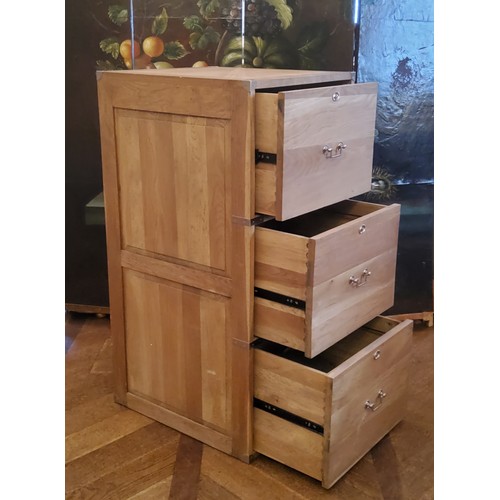 194 - A contemporary light oak campaign style three drawer filing cabinet with brass drop handles of good ... 