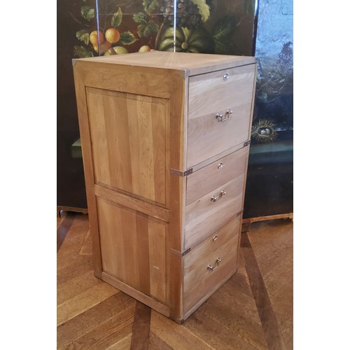 194 - A contemporary light oak campaign style three drawer filing cabinet with brass drop handles of good ... 