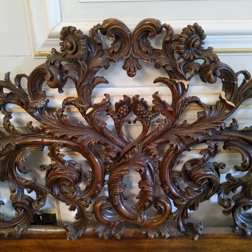 221 - A late 19th century Continental bed head, profusely carved throughout with acanthus scrolls (AF)