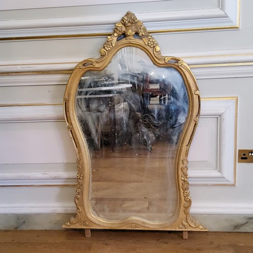 229 - A large decorative gilt framed mirror, in the Roccoco taste, 20th century