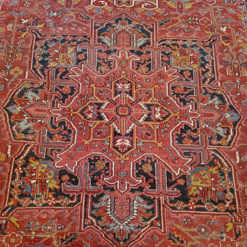 278 - A very large hand knotted Persian Heriz design carpet in rich tones of deep red, white and black