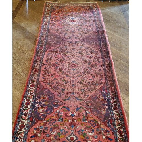 279 - A large hand knotted Hamadan runner with five elephant foot gourds, in tones of red and blue 487cm x... 