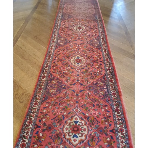 279 - A large hand knotted Hamadan runner with five elephant foot gourds, in tones of red and blue 487cm x... 