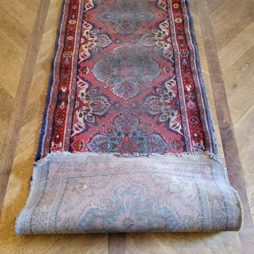 280 - A hand knotted Persian Sarab runner, in tones of turquoise and rich reds, 411cm long x 90cm