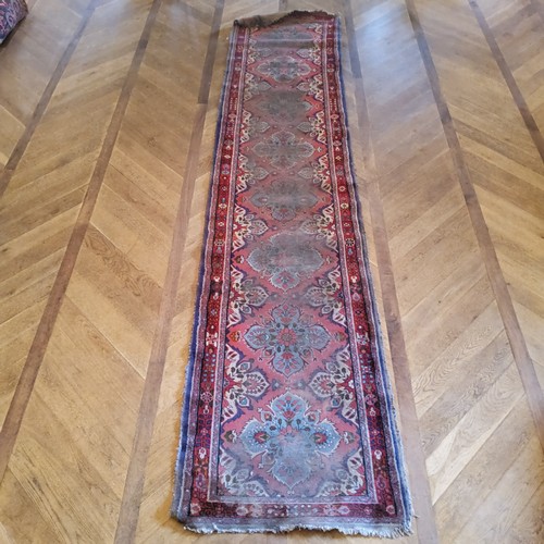 280 - A hand knotted Persian Sarab runner, in tones of turquoise and rich reds, 411cm long x 90cm