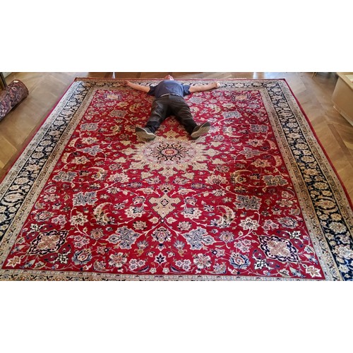 281 - A substantial Persian Najafabad carpet, the red ground carpet with large central medallion motif sur... 