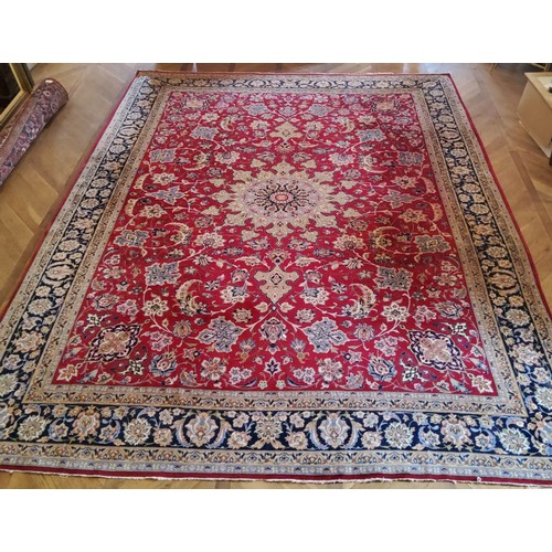 281 - A substantial Persian Najafabad carpet, the red ground carpet with large central medallion motif sur... 