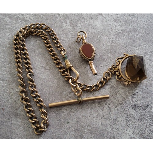 39 - A 9ct gold fob mounted with a spinning smokey topaz on a rolled gold Albert chain with T-bar; a gilt... 