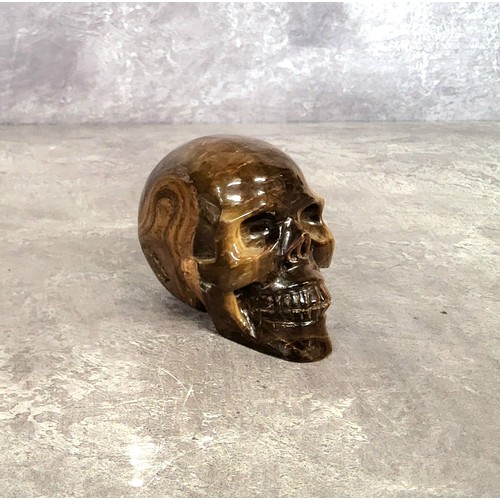 60 - A carved tiger's eye gemstone skull 6.5cms