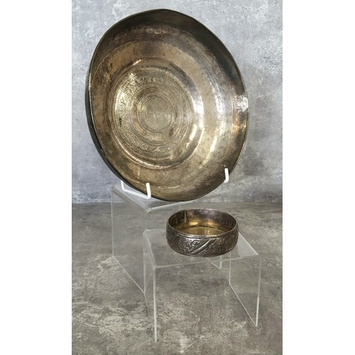 75 - An early 20th century Indian white metal bowl chased throughout with borders (tests as silver); a sm... 