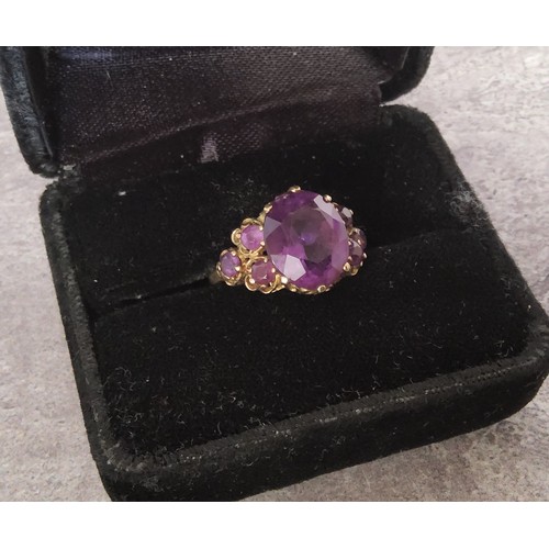 20 - A 9ct gold wedding band 3.17g; a 9ct gold ring set with four oval purple amethysts 3.55g; a 9ct gold... 