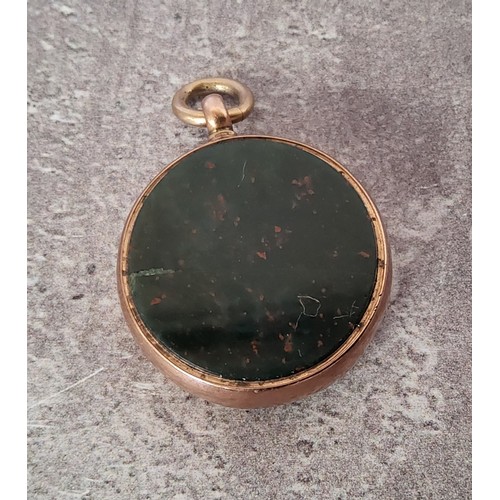 44 - A 9ct rose gold circular fob set with a blood stone one side, the other with a compass, the mother o... 