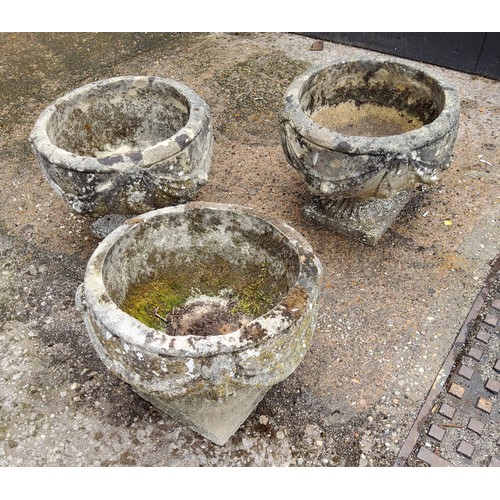 296 - A set of three squat cast concrete planter / urn,  depicting bows and fruits34cm h x 37.5 cm di... 