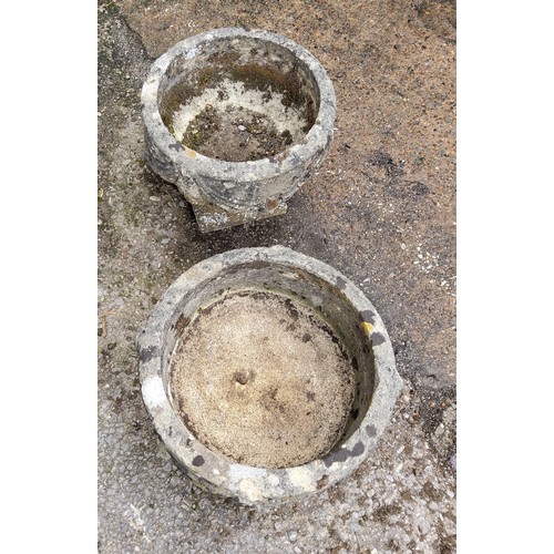 297 - A pair of squat cast concrete planters / urns with bows and fruits pattern. 34cm h x 37.5cm in dia