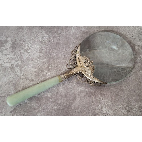 64A - An Oriental white metal mounted magnifying glass, jade handle 18 x 8cms