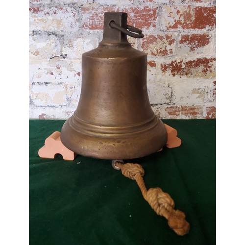 7 - A George V bronze ships bell with roped clapper, early 20th century. Height 28cm x diameter 24c... 