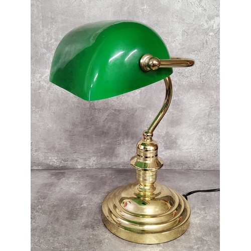 11 - A library desk reading lamp, swivel green shade on a turned brass weighted base