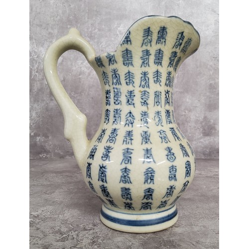 17 - Oriental Ceramics- a crackle glazed calligraphy jug, possibly Korean, 20cm high