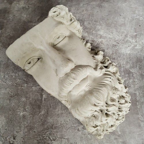 33 - Architectural Salvage - a reconstituted classical mask fragment 26cm high x 18cm w x 10cm d