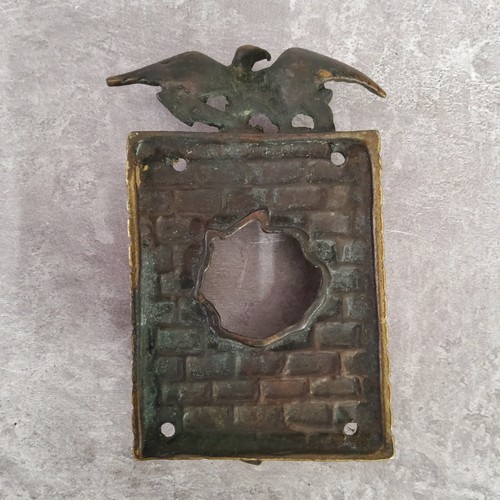 48 - An unusual early 20th century brass 'Hole In The Wall' door knocker / door bell surround surmounted ... 