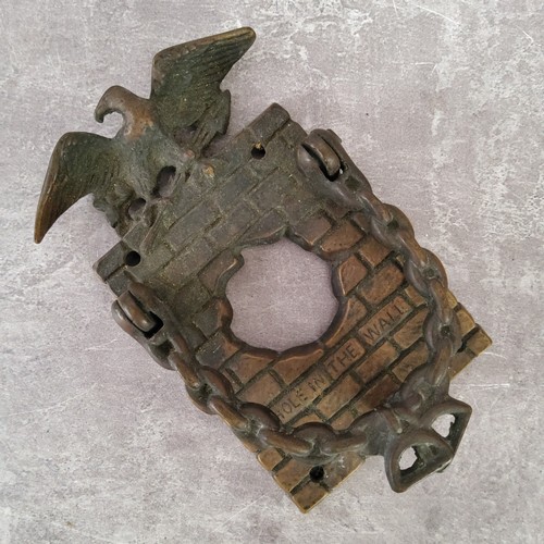 48 - An unusual early 20th century brass 'Hole In The Wall' door knocker / door bell surround surmounted ... 