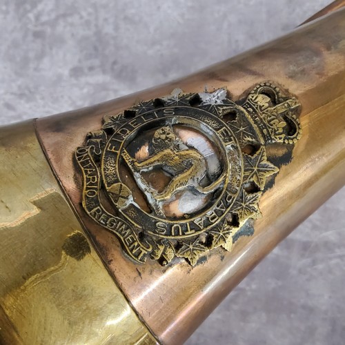 50 - Militaria - A WWI copper and brass bugle with Ontario Regiment badge of a cat with arched back withi... 