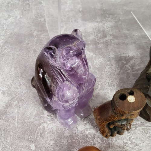 104 - Oriental Objects - A Chinese carved amethyst or quartz monkey; Japanese netsuke in the form of a han... 