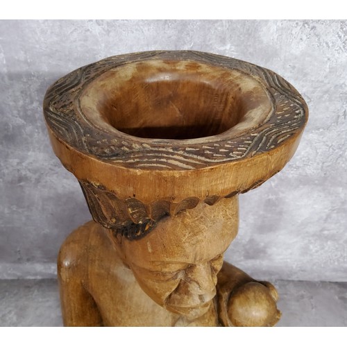 105 - Tribal - a substantial African offertory bowl carved as a seated woman, she sits 45cm high