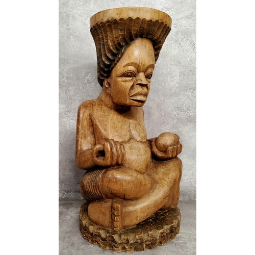 105 - Tribal - a substantial African offertory bowl carved as a seated woman, she sits 45cm high