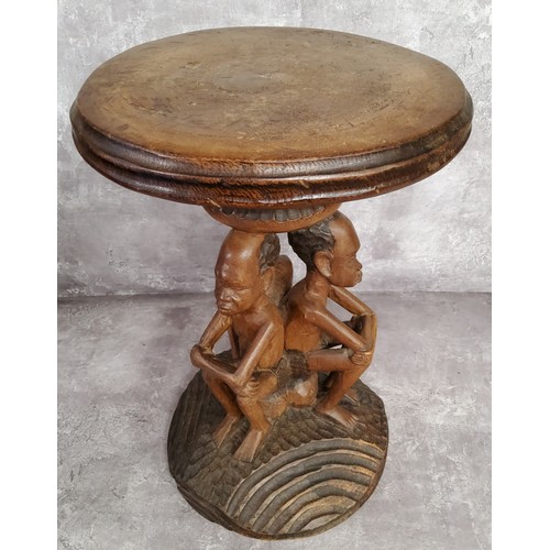 109 - Tribal - a 20th century African elder carving with three seated male carved column, with carved base... 