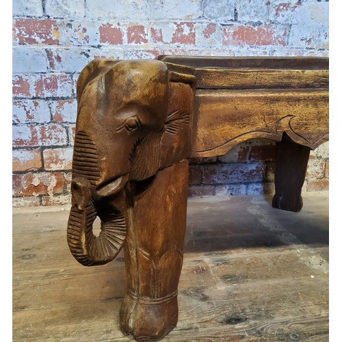 115 - Tribal - A 20th century tribal occasional table with ornately carved legs depicting elephants.Height... 