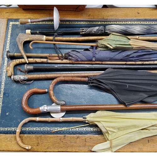 140 - Walking sticks and parasols including a Victorian silver mounted walking cane, ebonised shaft; Scott... 