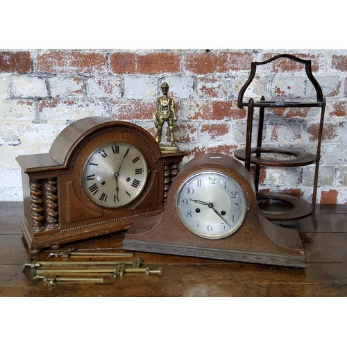 168 - A bold early 20th century oak mantel clock with barley twist columns, with key; another Napoleon sha... 