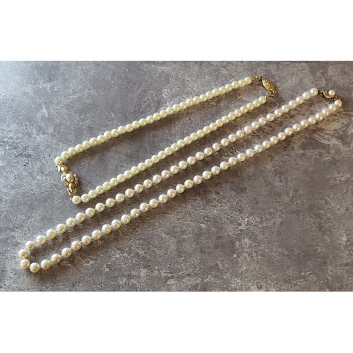 106 - A pearl necklace (slight blush colour) 9ct gold clasp set with a central pearl; another faux pearls;