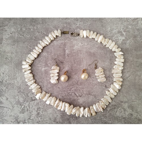 108 - An impressive single strand of seventy one large white, pink and peach baroque pearl necklace; a con... 