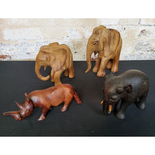 134 - Tribal - a large collection of African carved animals, carved magazine  rack, imparla 35cm heig... 