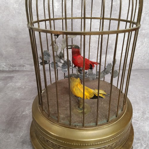 143 - An early 20th Century birdcage automaton with decorative pressed brass base and cage containing two ... 