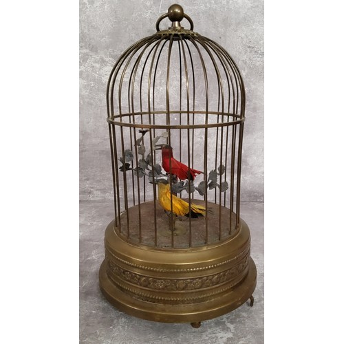 143 - An early 20th Century birdcage automaton with decorative pressed brass base and cage containing two ... 