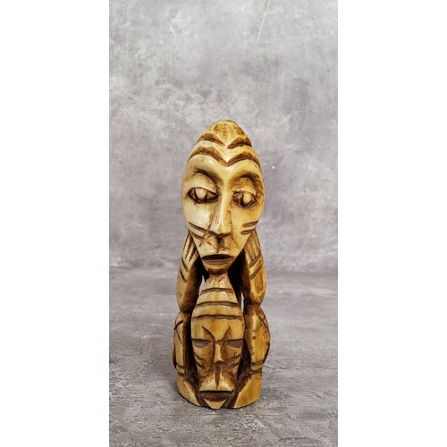 148 - AMENDED DESCRIPTION: an African leg bone carving, 11cm