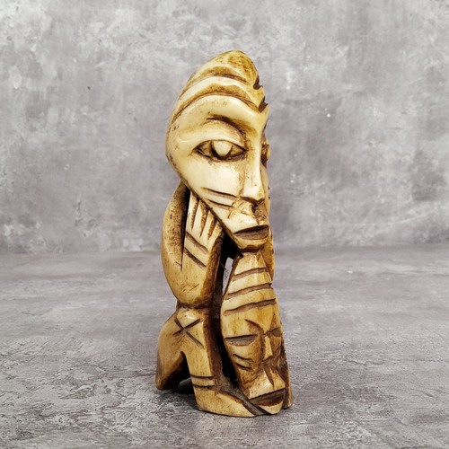 148 - AMENDED DESCRIPTION: an African leg bone carving, 11cm