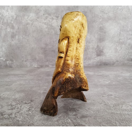 149 - Amended Description an African leg bone carving