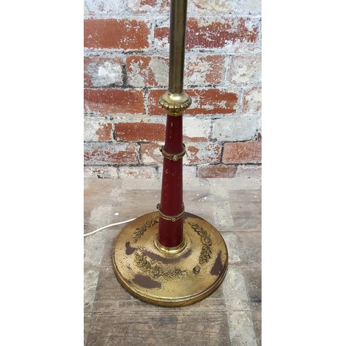 179 - An early 20th century toleware and gilt metal mounted standard lamp, weighted base, with shade 155cm... 